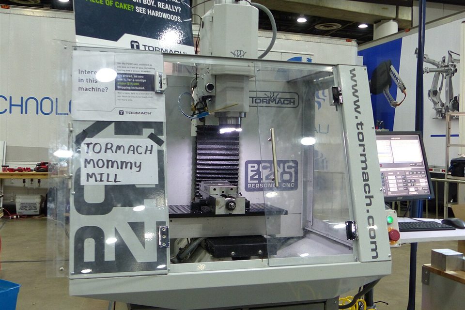 A CNC mill on an industrial workshop floor