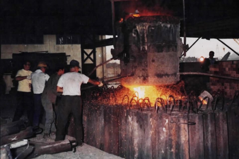 Molten metal being poured inside a steel foundry